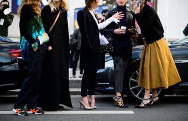 A group of women are standing next to each other on a street.