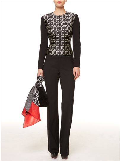 A woman is wearing a black top and black pants