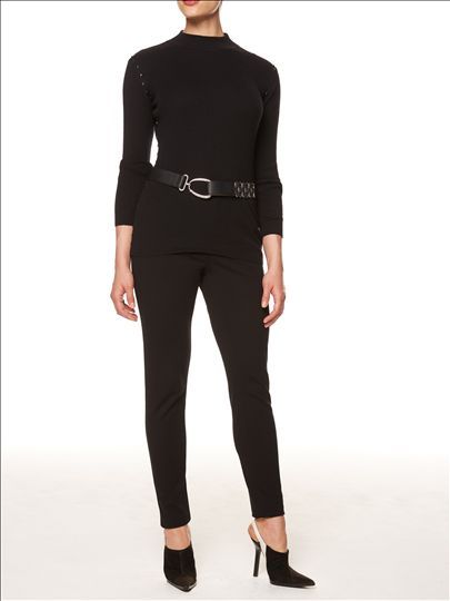 A woman is wearing a black top and black pants