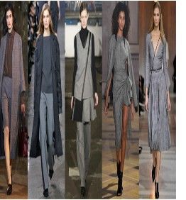 A group of women are walking down a runway wearing gray clothes.