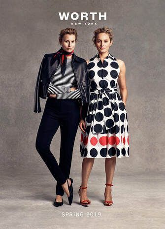 Two women are standing next to each other wearing polka dot dresses.