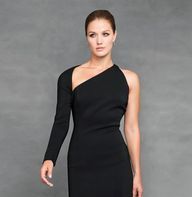 A woman is wearing a black one shoulder dress.