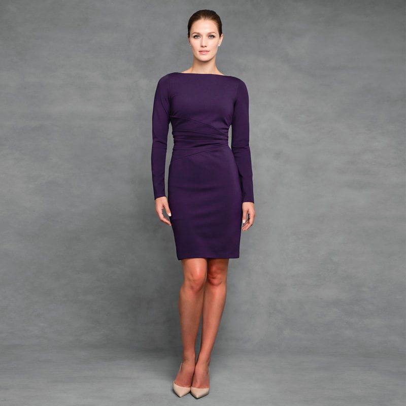A woman is wearing a purple dress with long sleeves