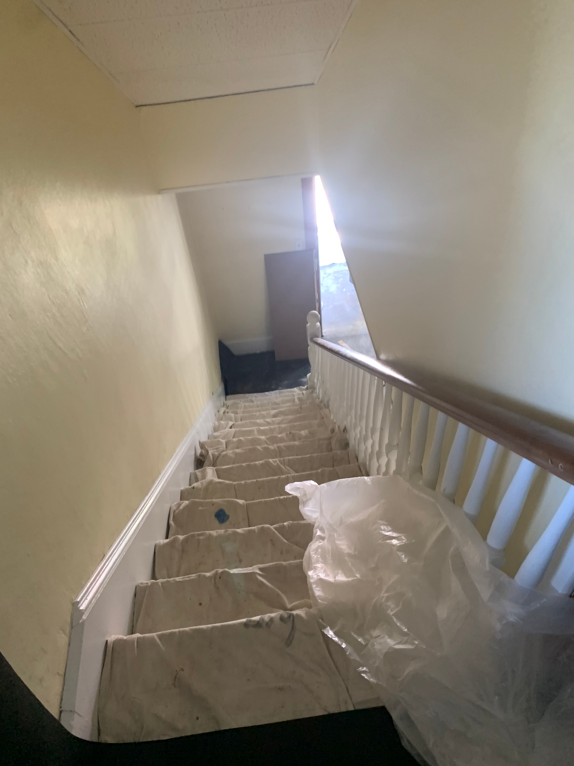 A staircase with a plastic bag on the bottom of it
