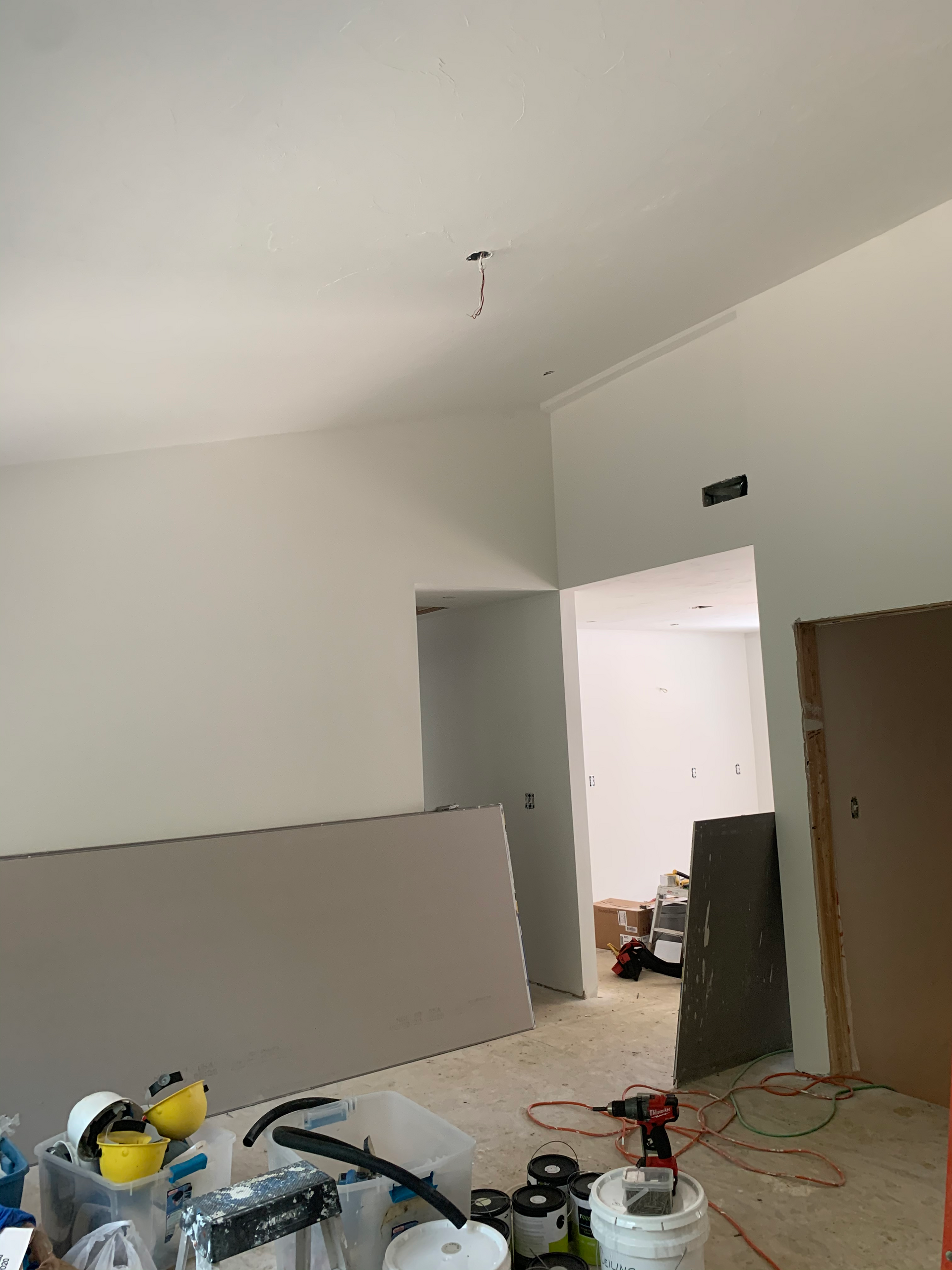 A room with white walls and a lot of tools on the floor.