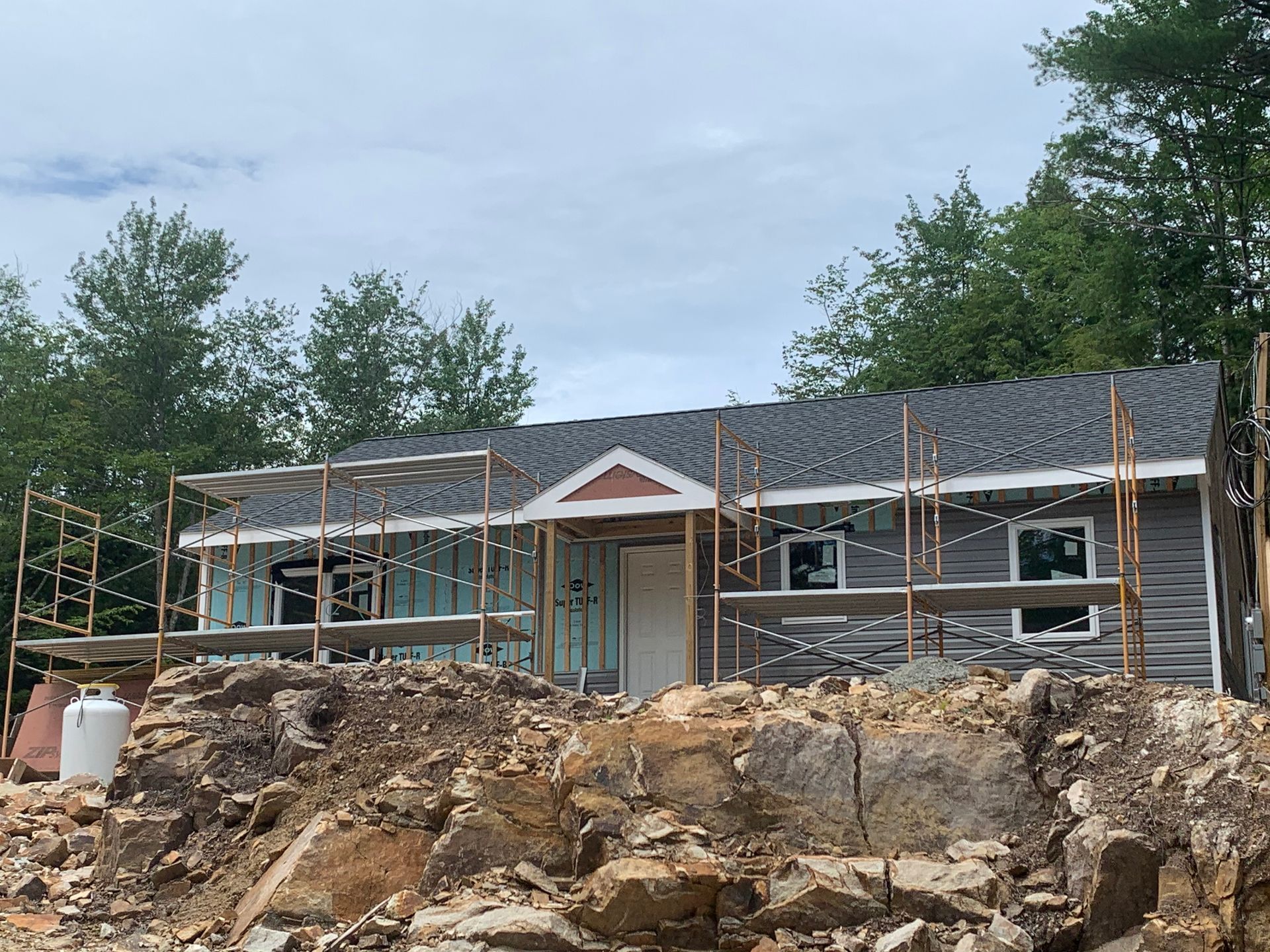 A house is being built on top of a pile of rocks.