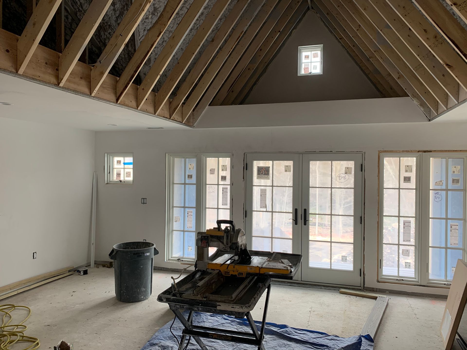 A room with a lot of windows and a ceiling that is being built