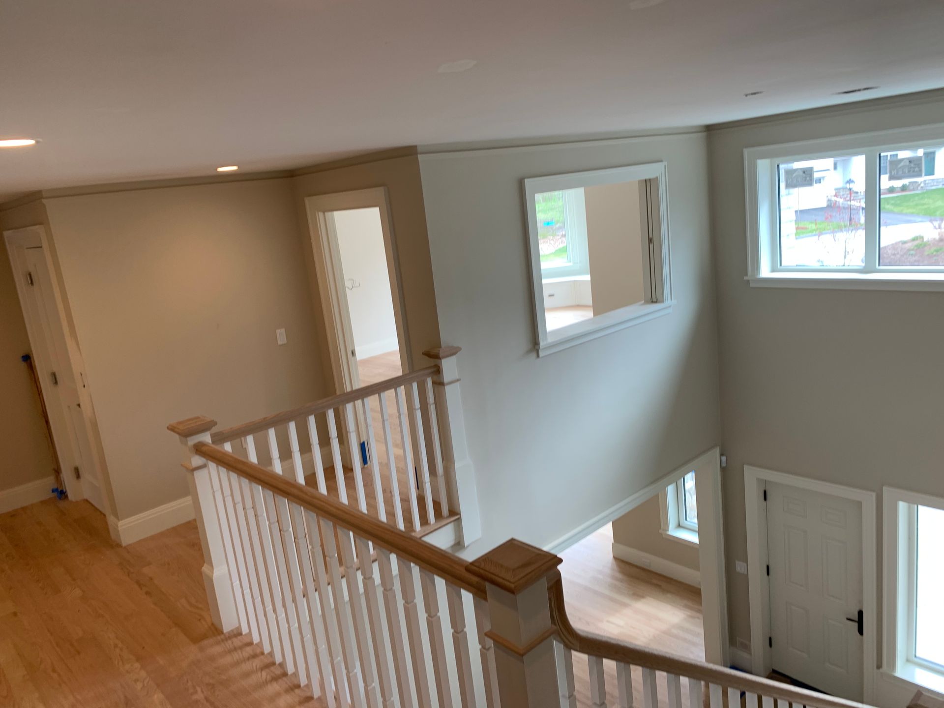 A view of a staircase from the second floor of a house.