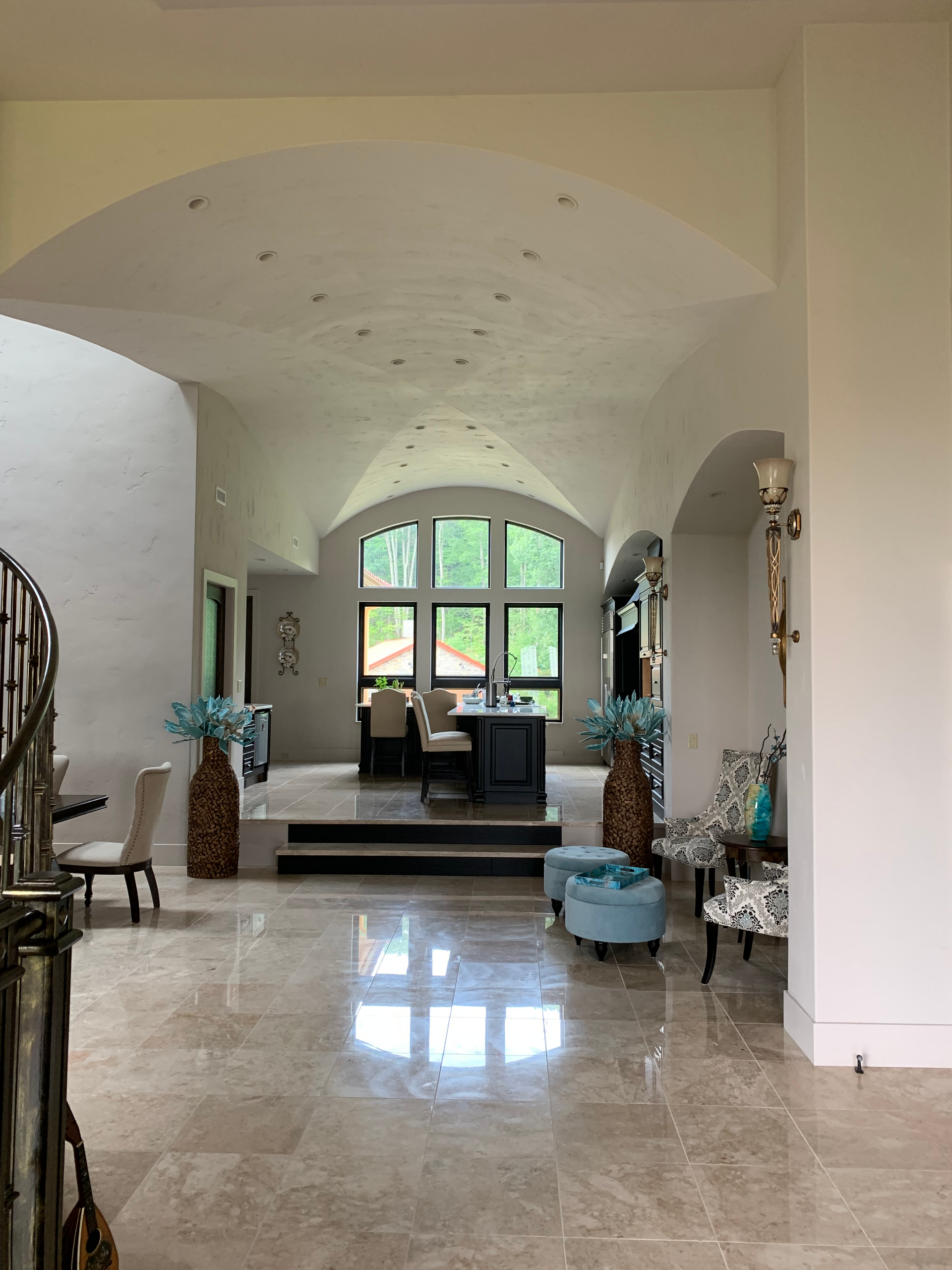 A large living room with a staircase leading up to the second floor.