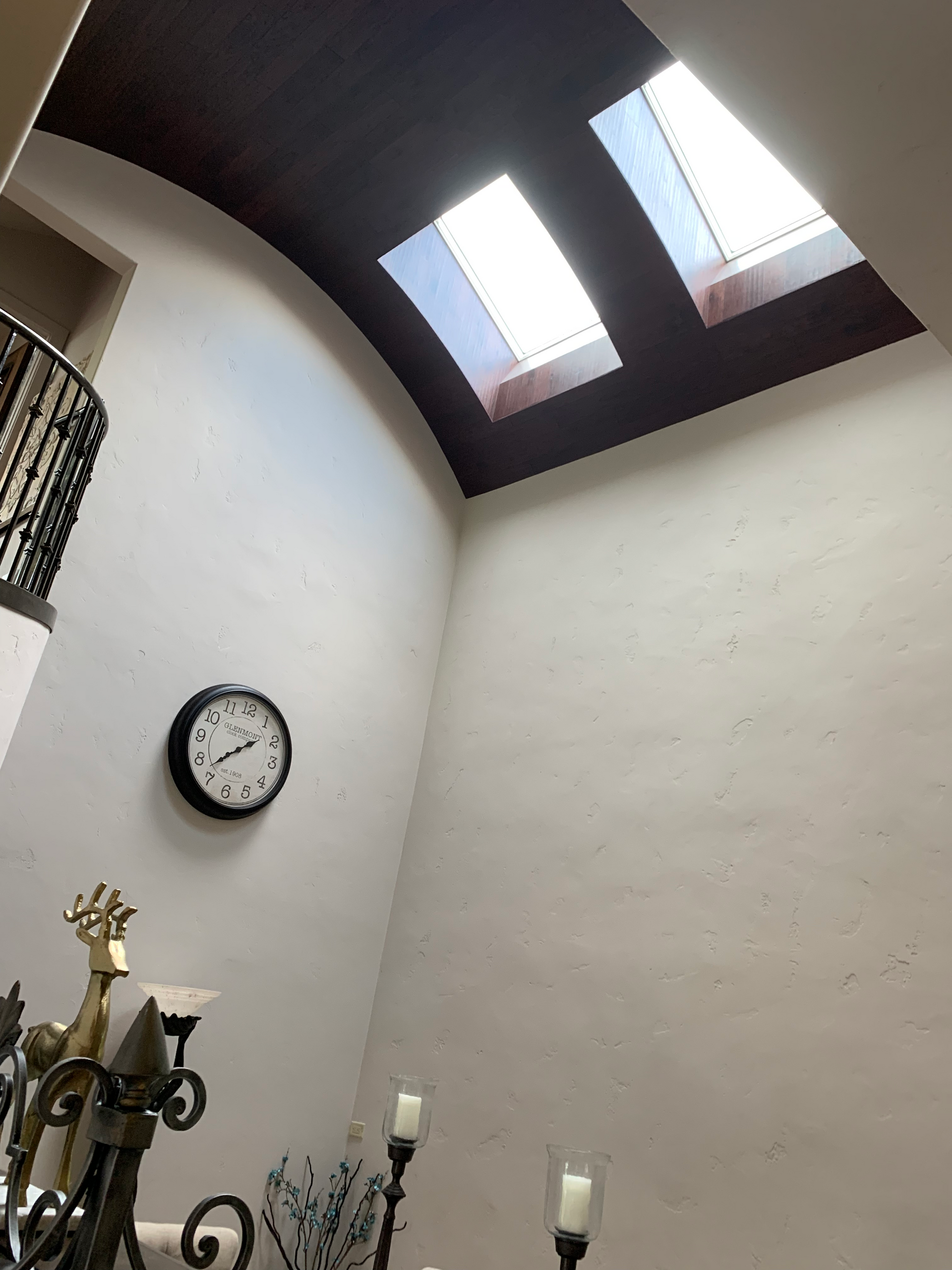 A clock hanging on a wall shows the time as 4:20