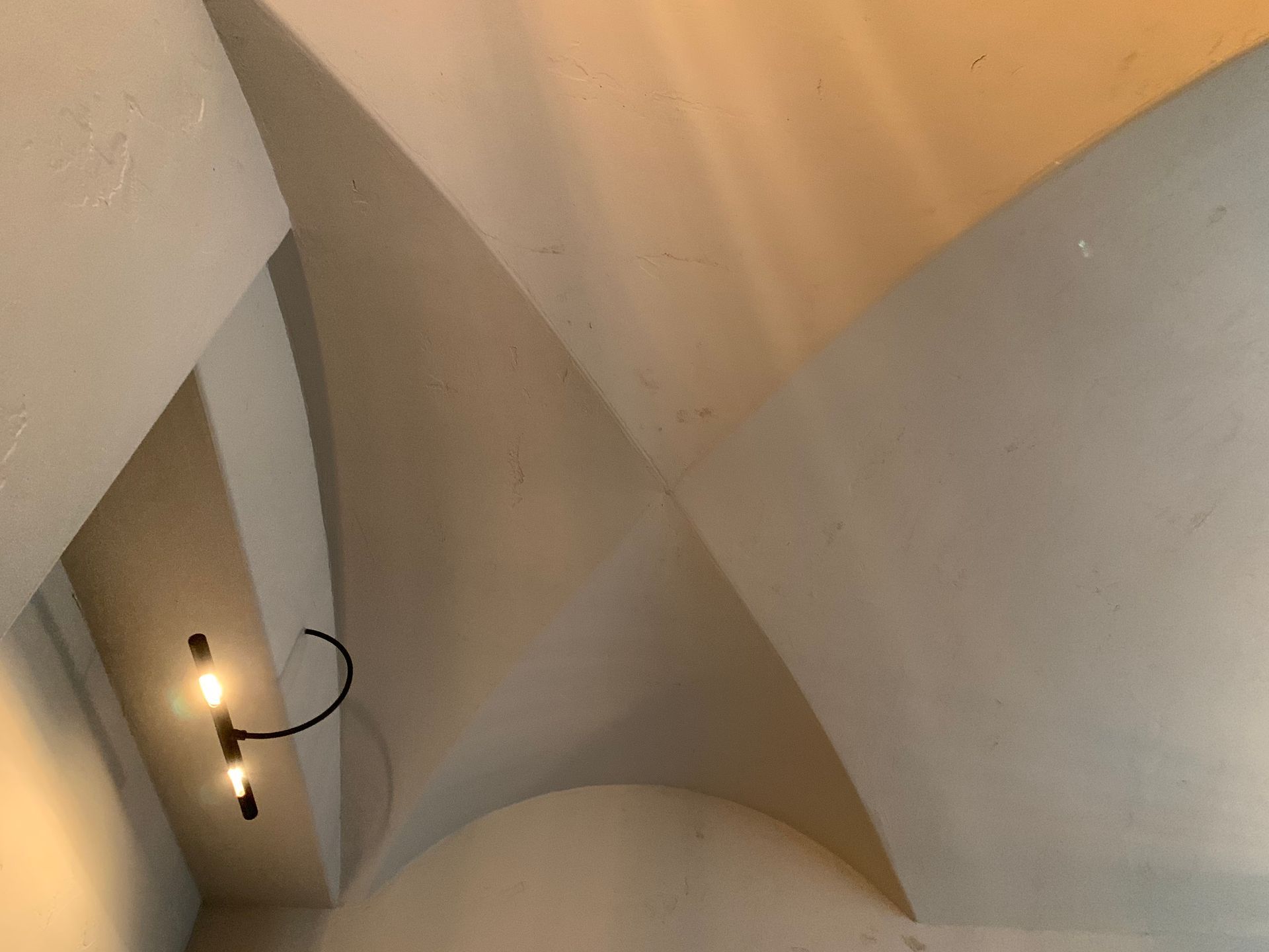 A light is hanging from the ceiling of a building.