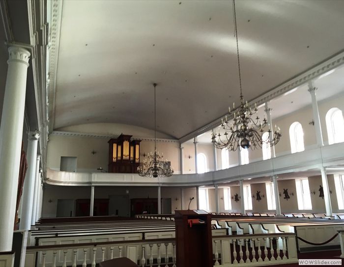 The inside of a church with a chandelier hanging from the ceiling