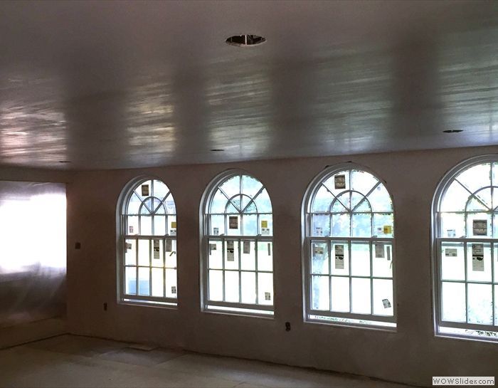 A room with arched windows and a white ceiling