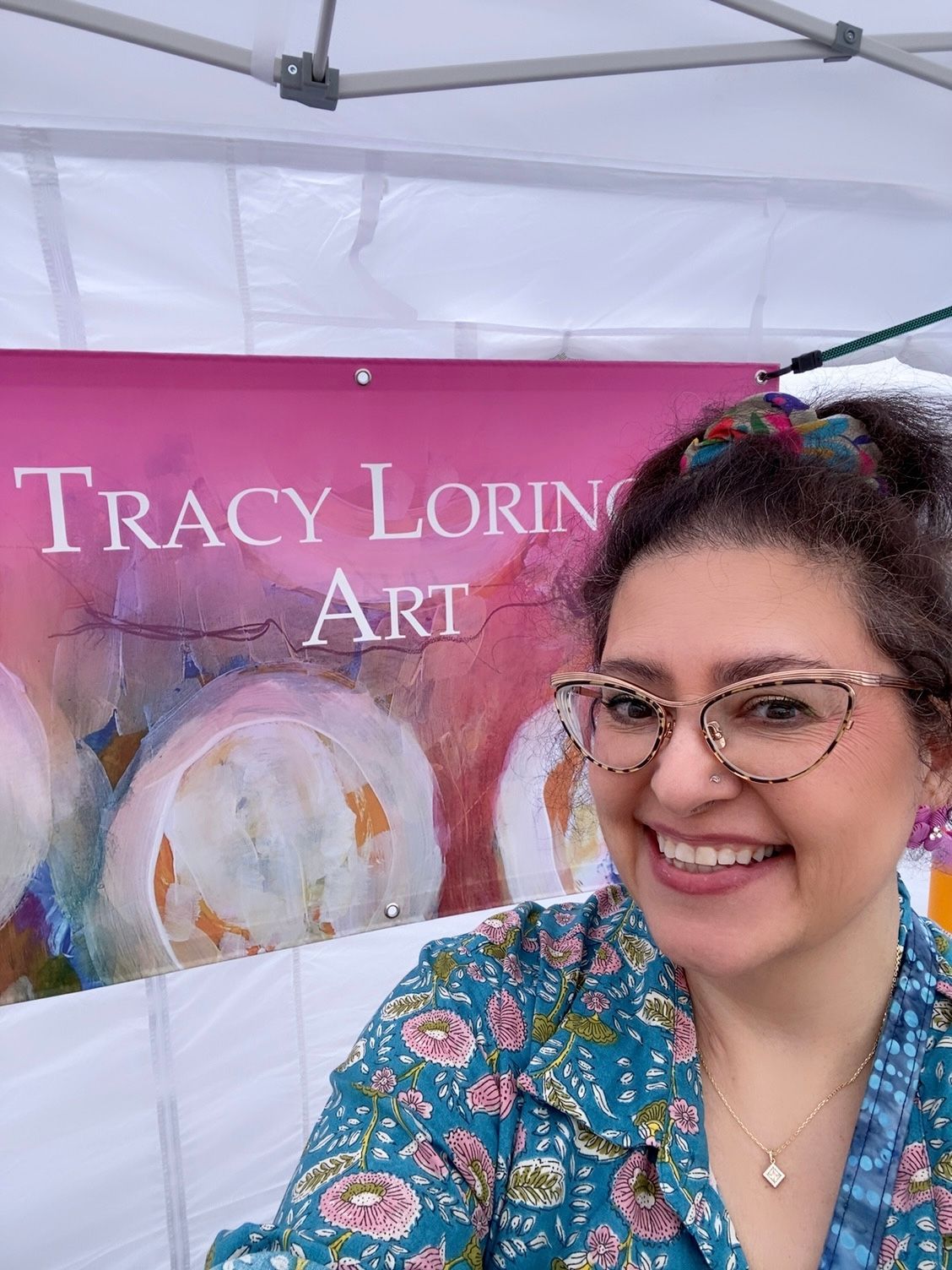 Woman smiling in front of a 