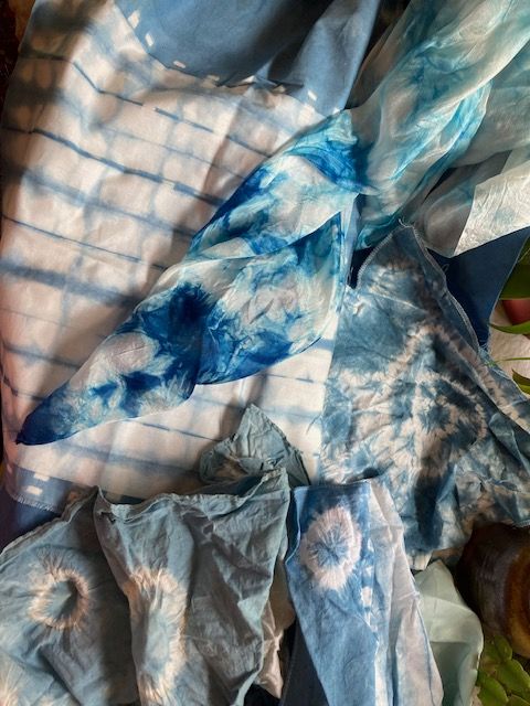 Blue and white tie-dye fabric, folded and bunched.