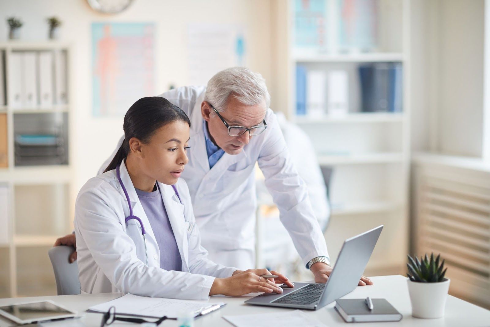 Healthcare providers discuss senior care strategies using data from PACE management software. 