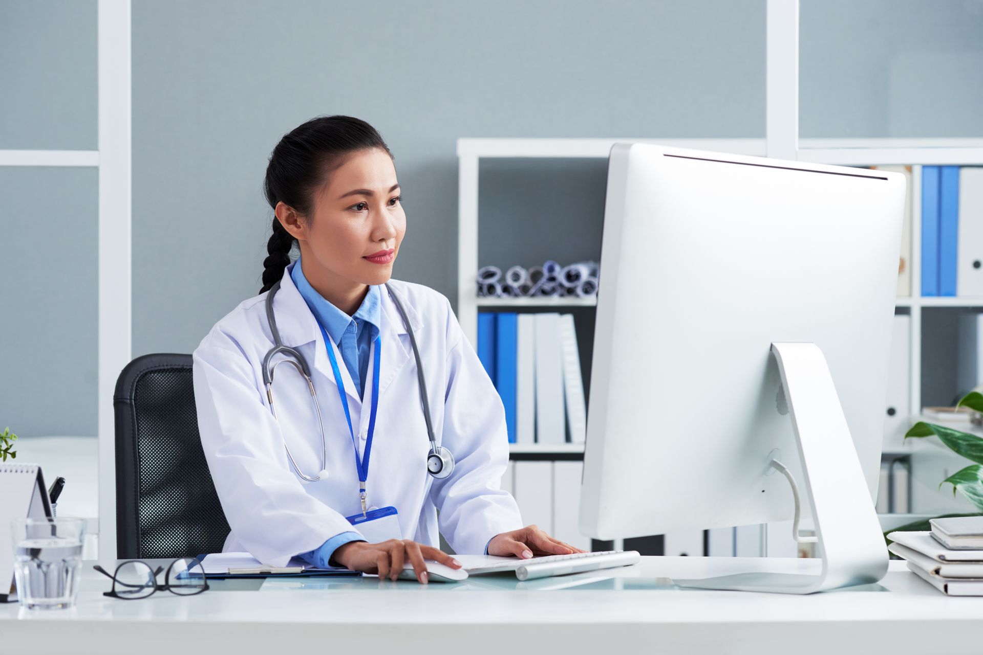A doctor streamlines workflows using integrated software for managed care providers and payers. 