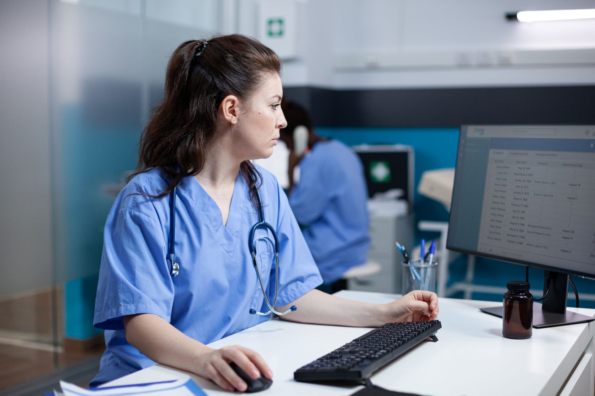 A nurse navigates the PACE operating system to check patient appointments and health records.