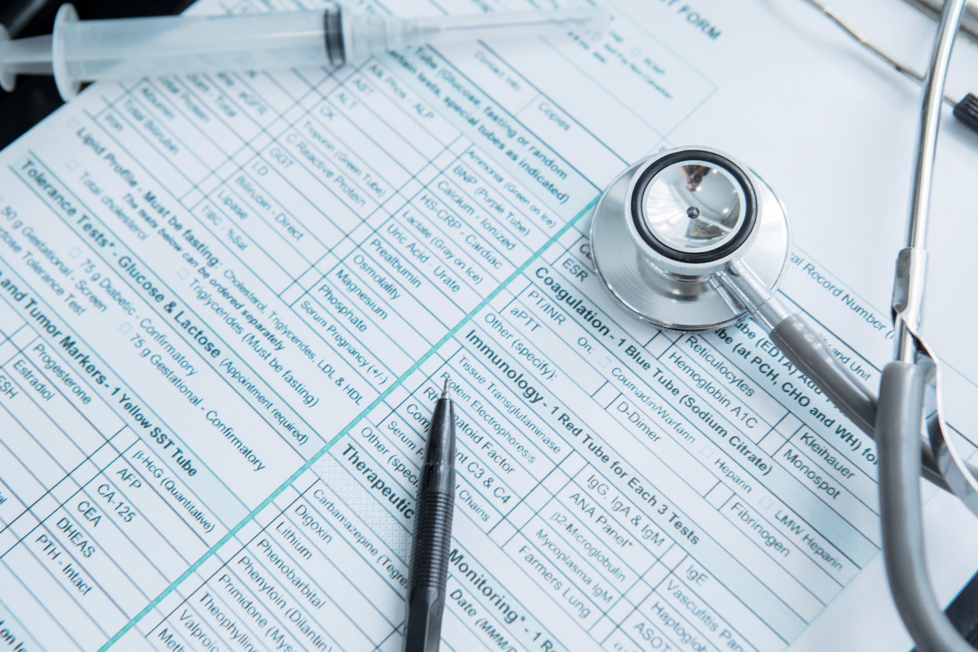 A stethoscope is sitting on top of a medical form