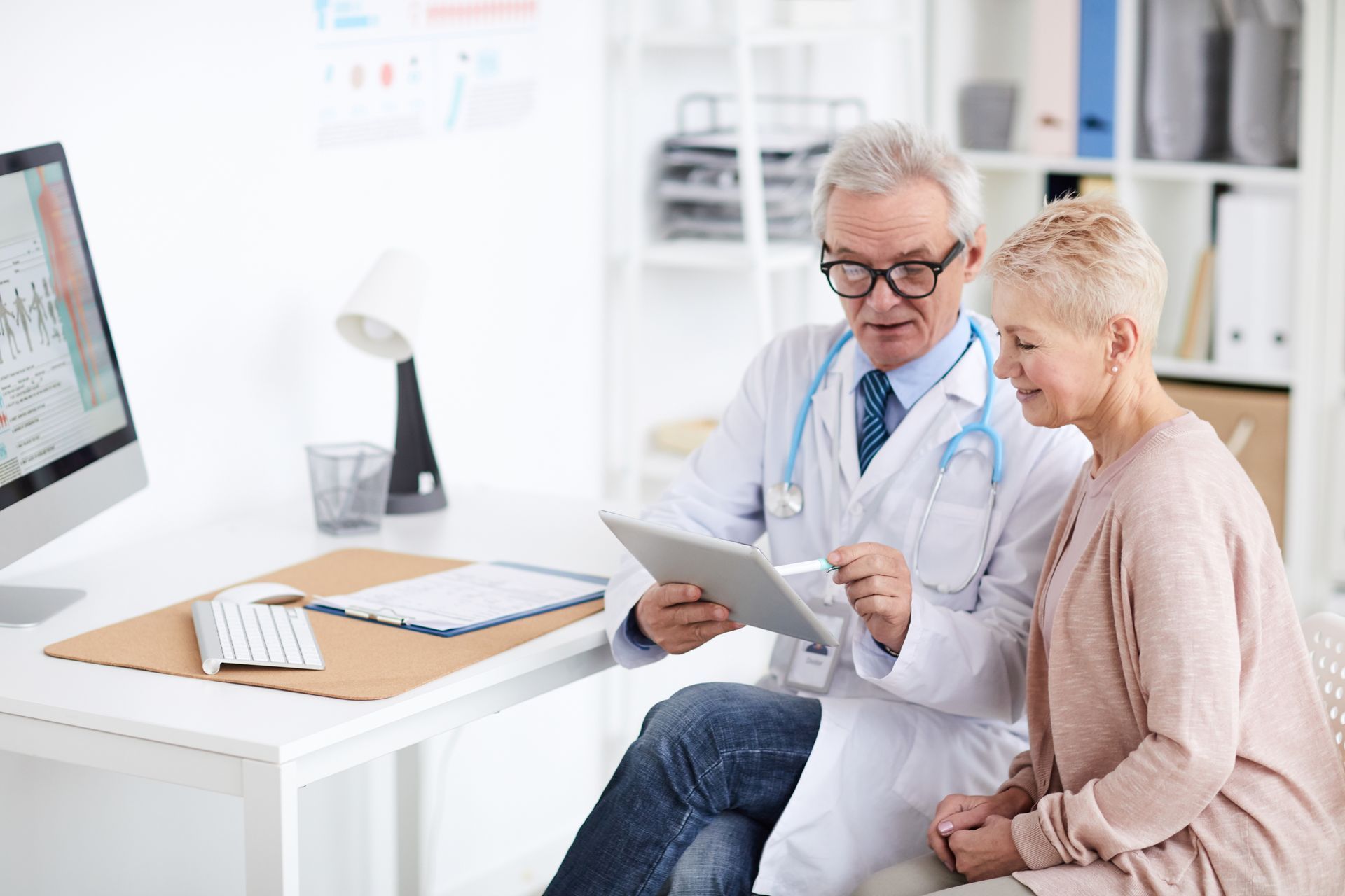 A doctor showing a patient how modern PACE software can help develop informed decisions efficiently.