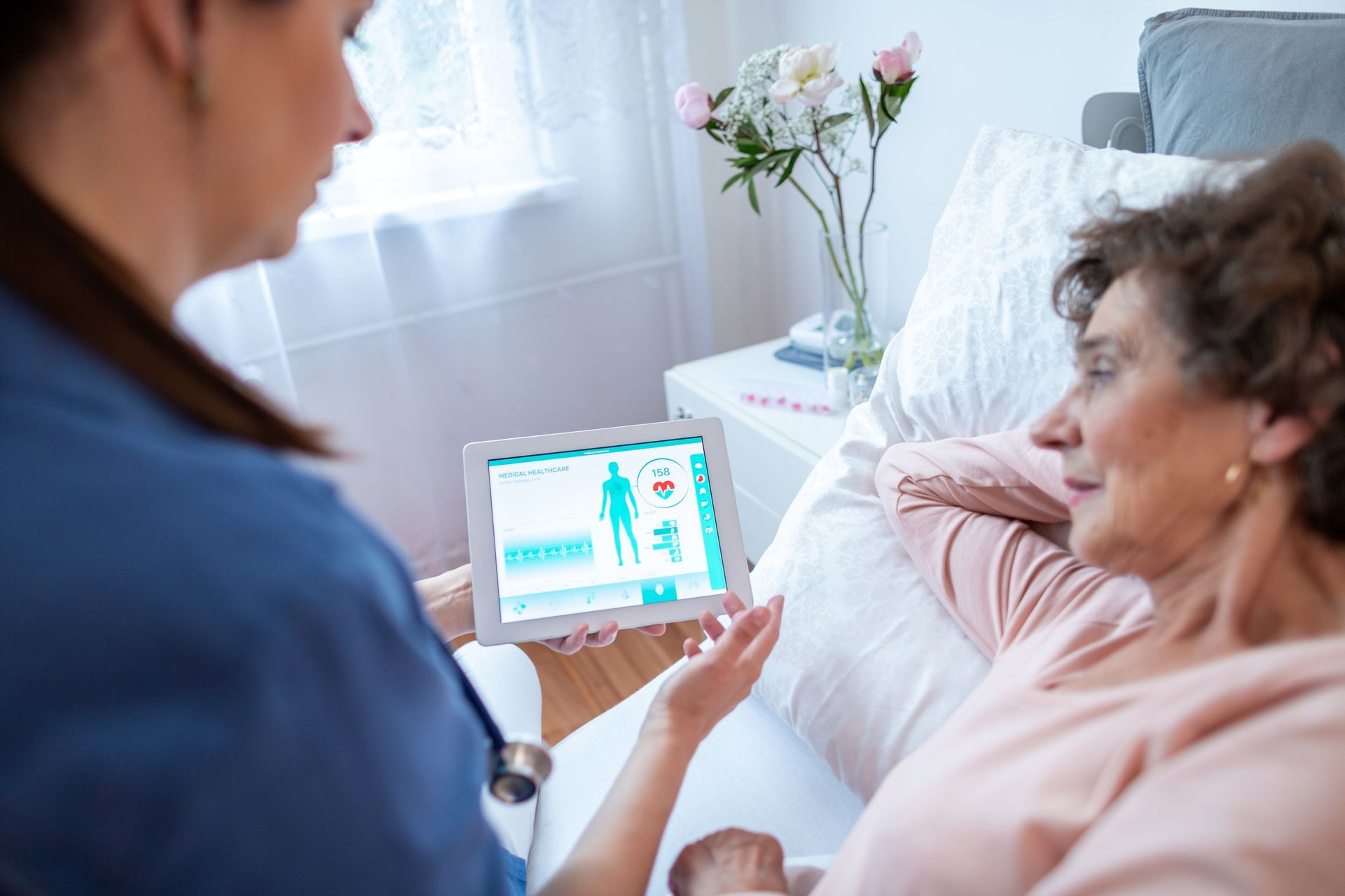 A nurse utilizing predictive analytics to help their patient understand about their condition.