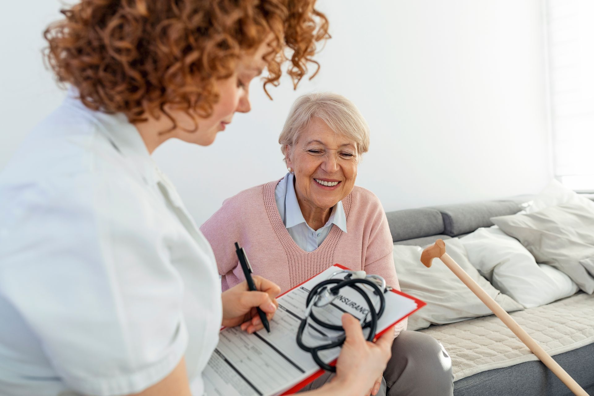 Senior women under the PACE program meet with a caregiver to discuss healthcare needs.