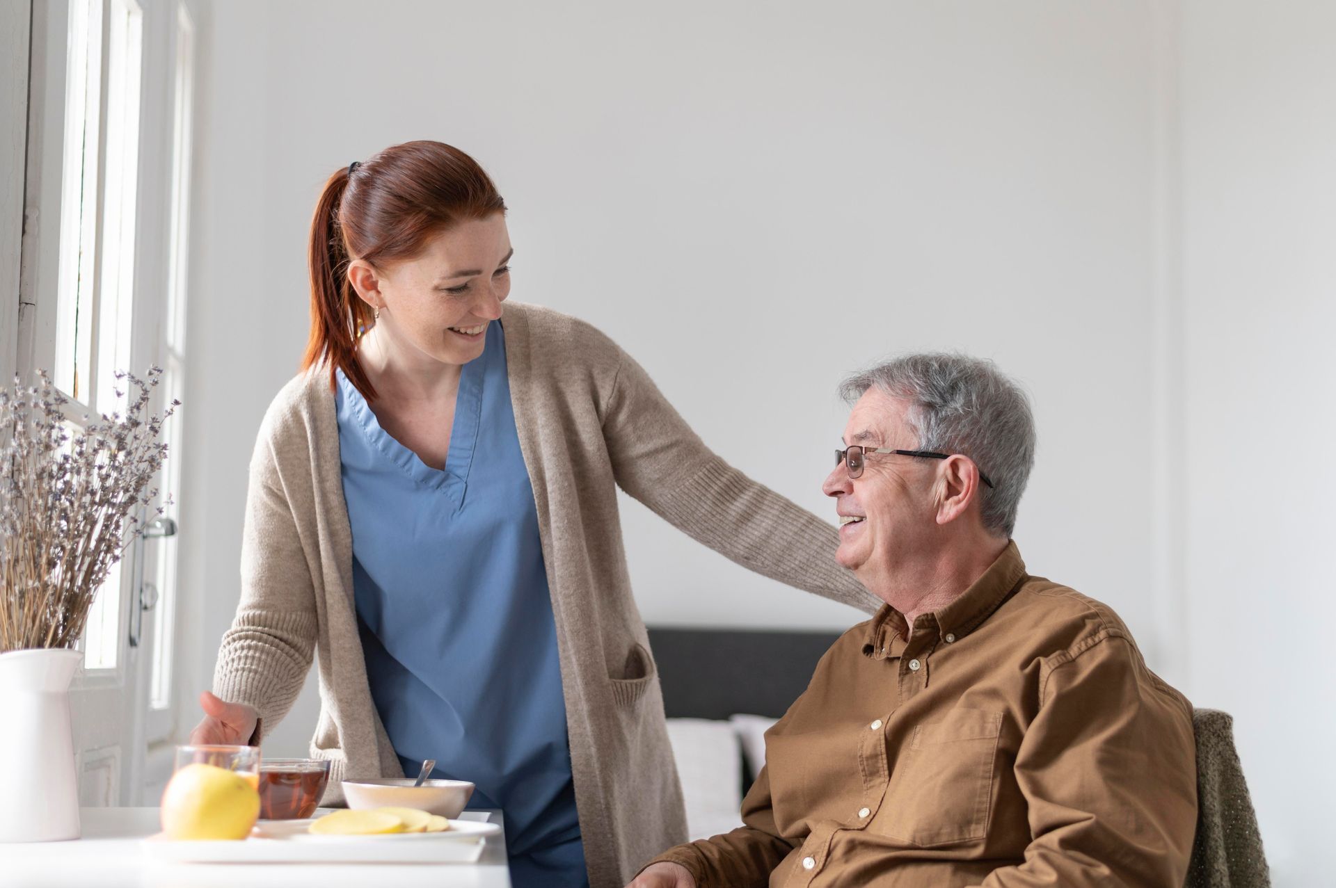 Healthcare staff talking to an older adult, showcasing senior care