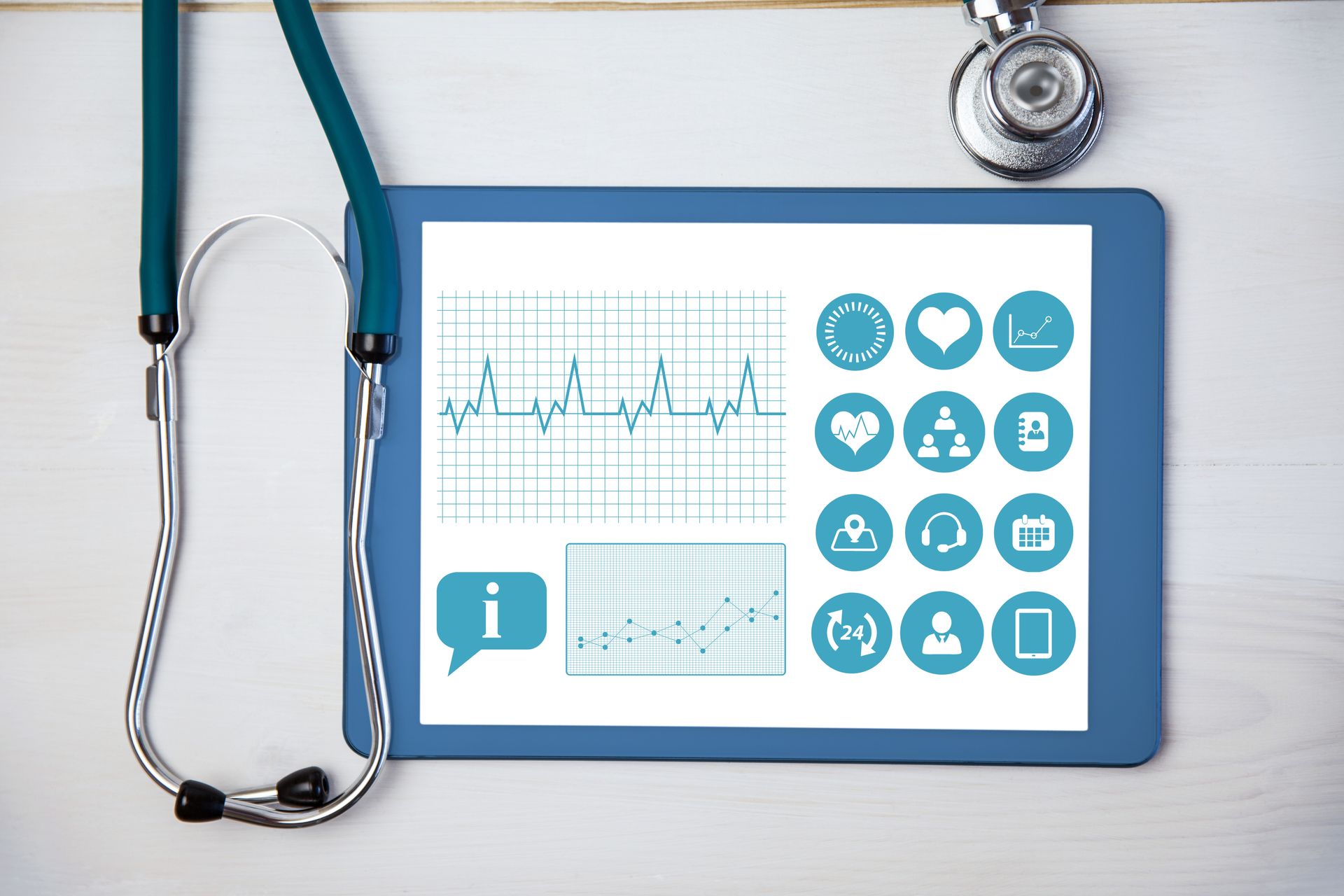 Tablet displaying healthcare analytics with different health icons and data charts alongside a stethoscope.