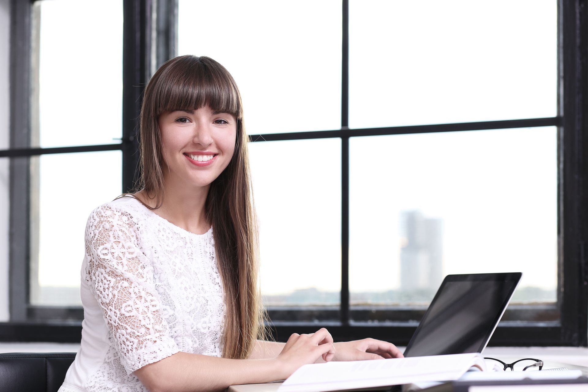 A woman in an office using BPaaS solutions in modern business operations for operational efficiency.