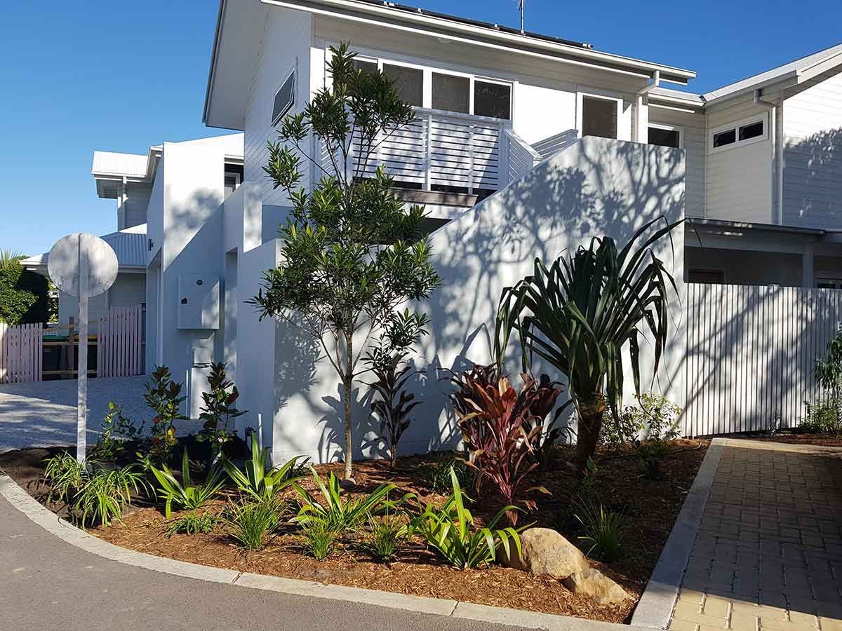 A White House With a Lot of Plants in Front of It — Full Circle Landscaping in Currumbin Valley, QLD