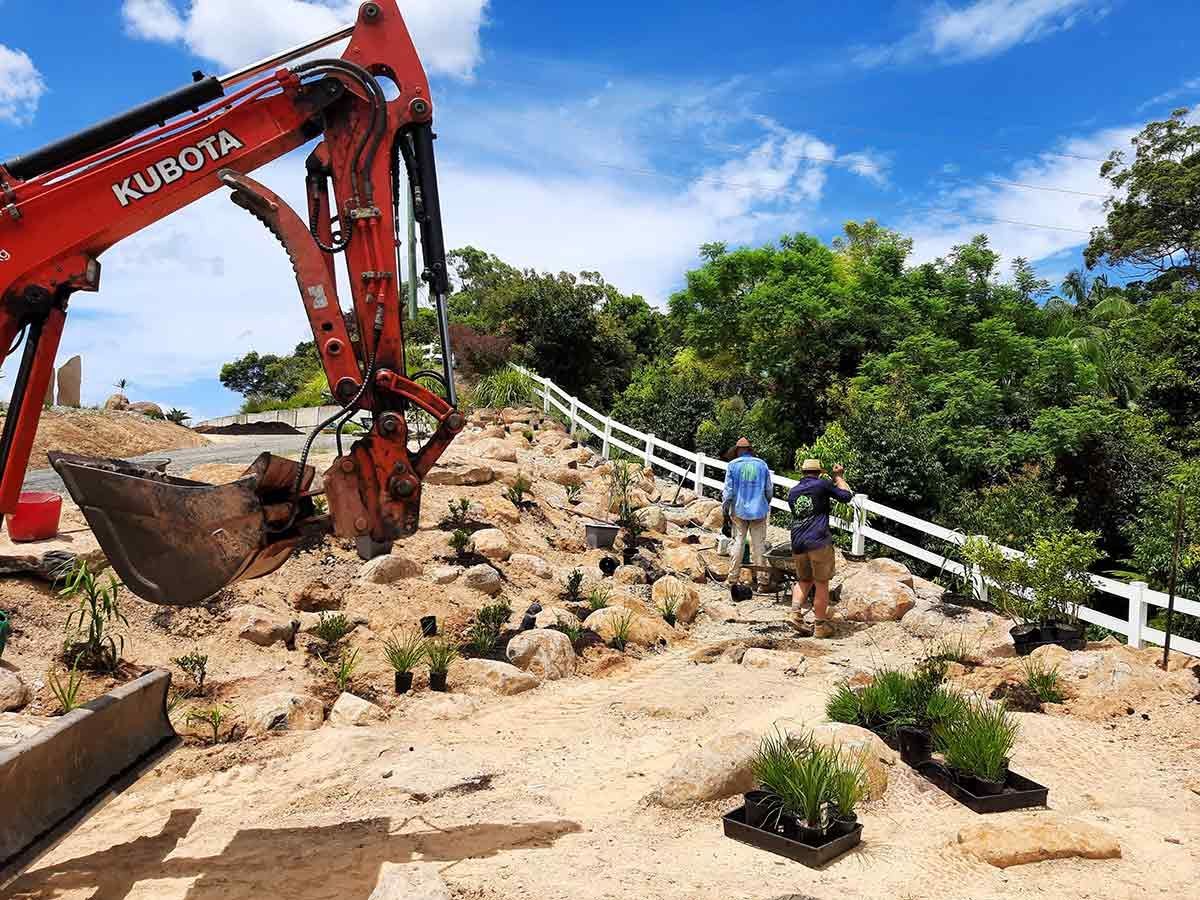 A Kubota Excavator is Digging a Hole in the Ground — Full Circle Landscaping in Currumbin Valley, QLD