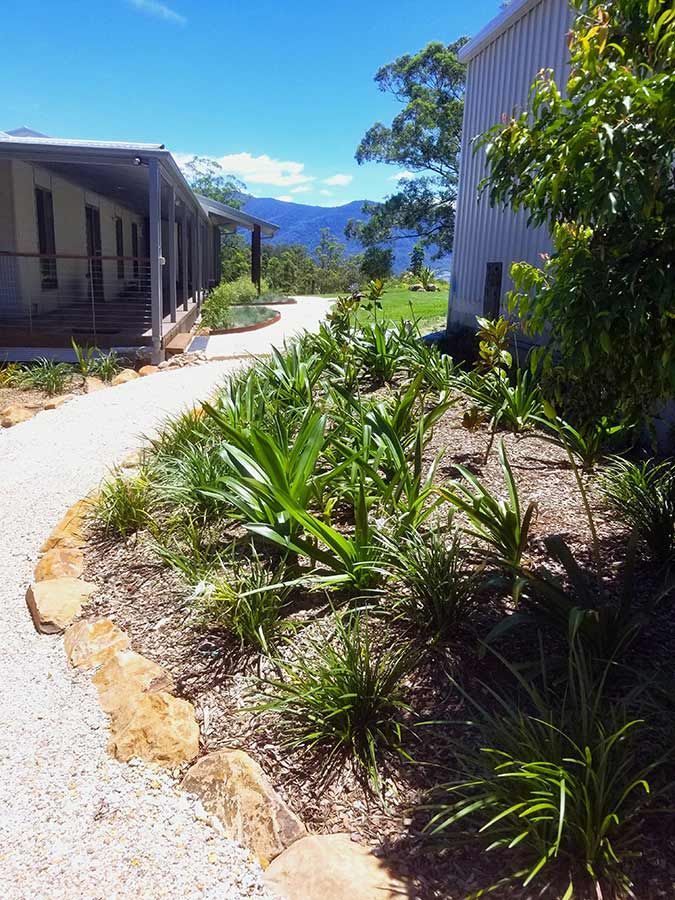 A Path Leading to a House Surrounded by Plants and Rocks — Full Circle Landscaping in Ballina, NSW