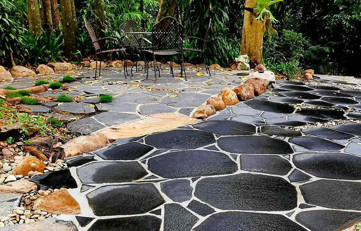 A Stone Walkway in a Garden With a Bench in the Background — Full Circle Landscaping in Murwillumbah, NSW