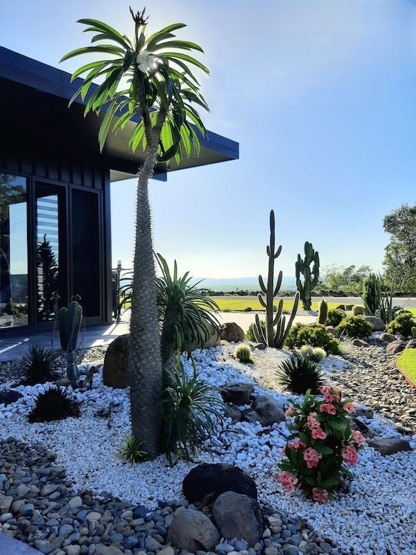 A White Fence Is Sitting On Top Of A Rocky Hill — Full Circle Landscaping in Uki, NSW