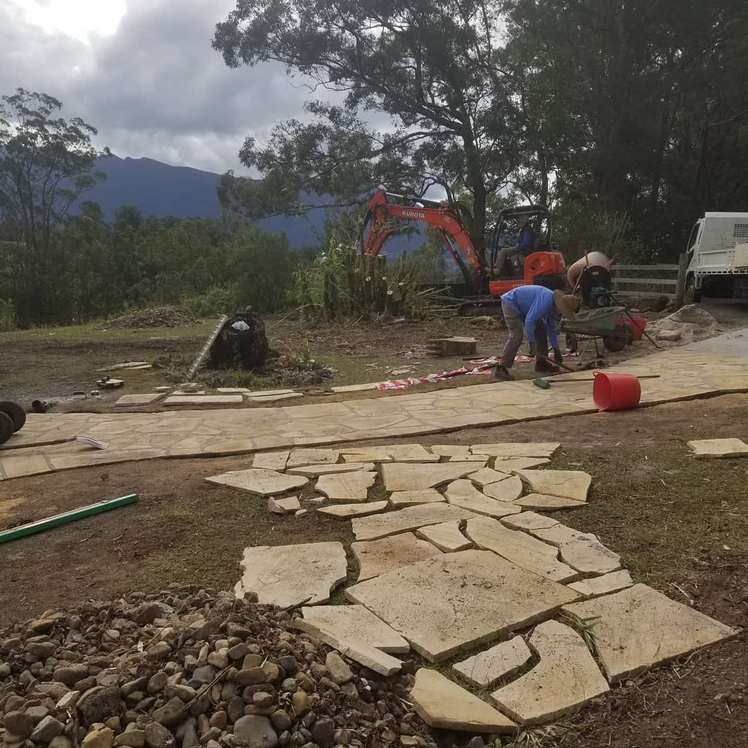 A Group Of People Are Working On A Stone Walkway — Full Circle Landscaping in Uki, NSW