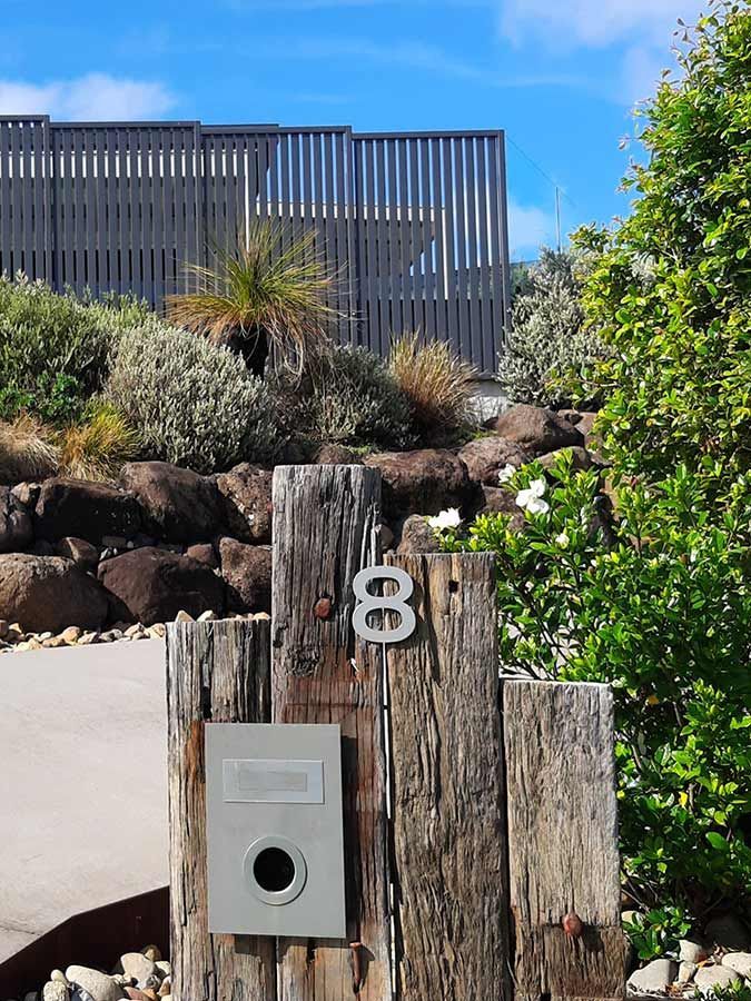 A Wooden Post With the Number 8 on It — Full Circle Landscaping in Tweed Heads, NSW