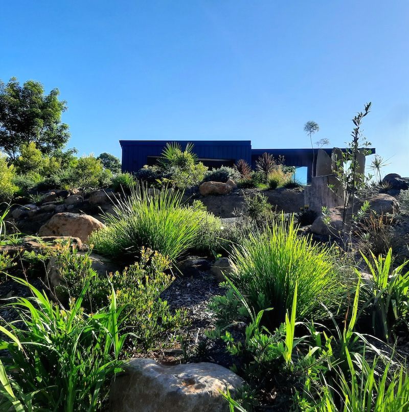 A Stone Walkway Leading To A Bench In A Garden — Full Circle Landscaping in Uki, NSW