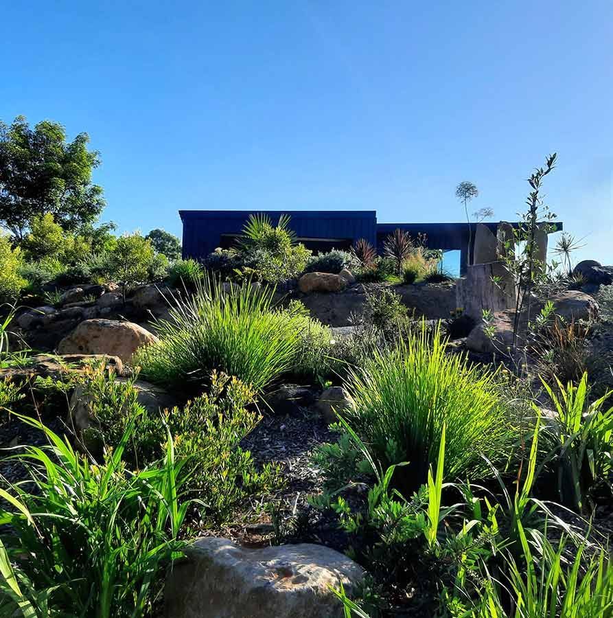 A House is Surrounded by Lots of Plants and Rocks — Full Circle Landscaping in Tweed Heads, NSW