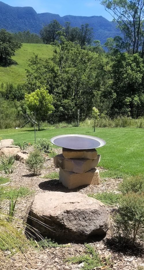 A Small Pond Surrounded By Rocks And Plants In A Garden — Full Circle Landscaping in Uki, NSW