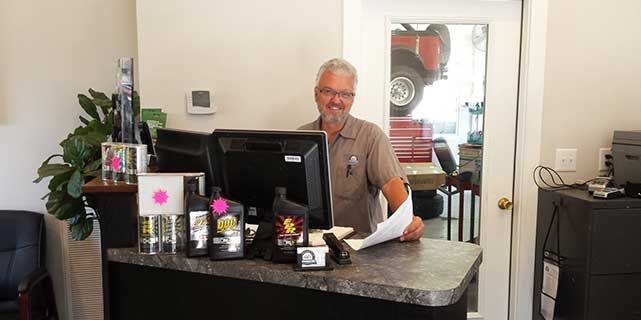 Person behind a counter in an auto repair shop. | Fincastle Automotive