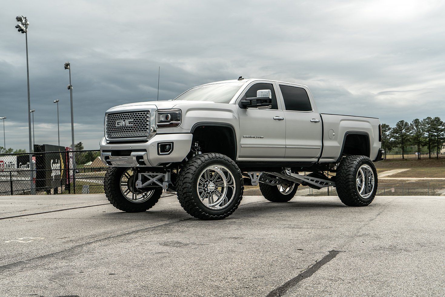 a white truck is parked on the side of the road .