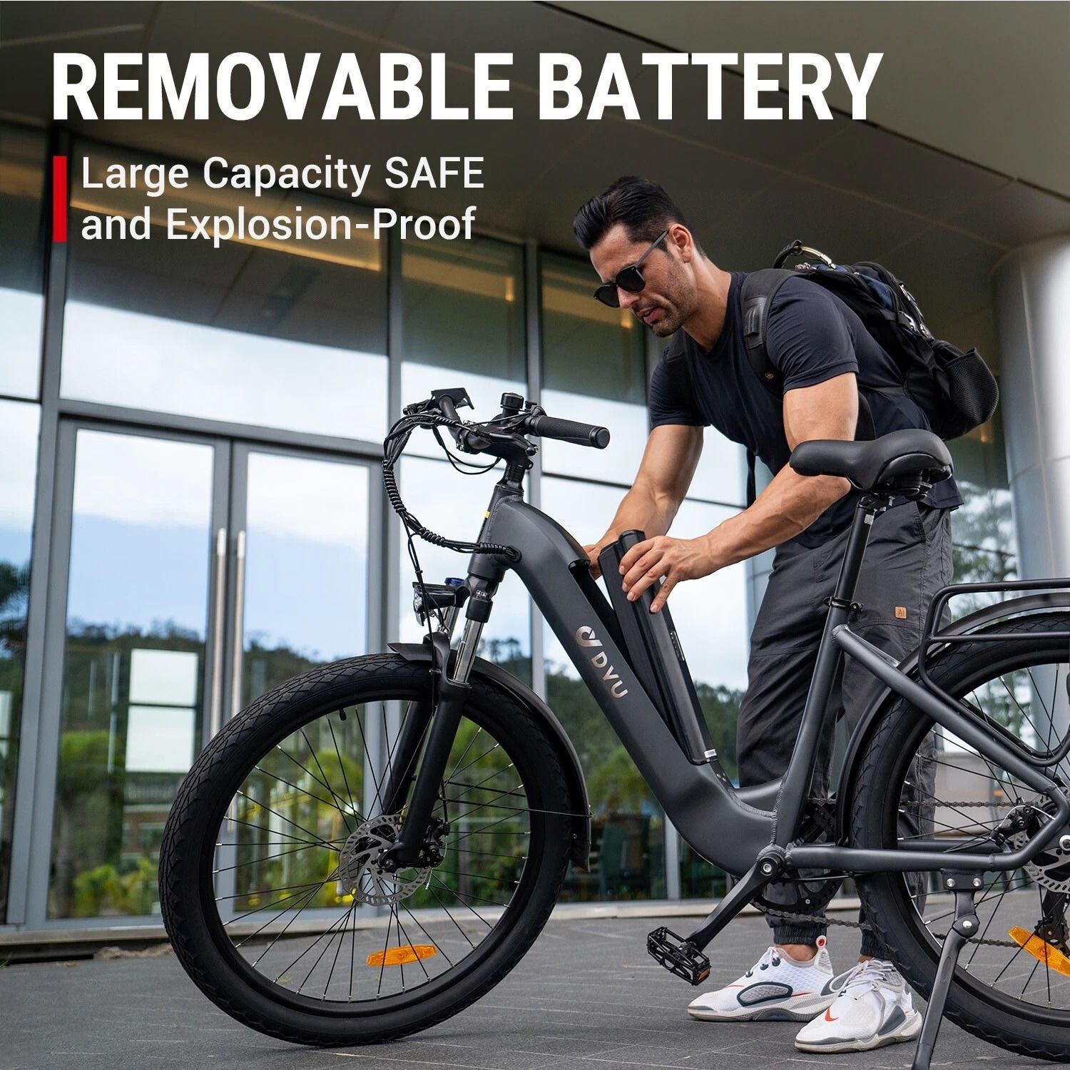 A man is standing next to an electric bike with a removable battery.