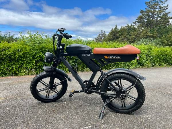 An MV30 electric motorcycle is parked on the side of the road.