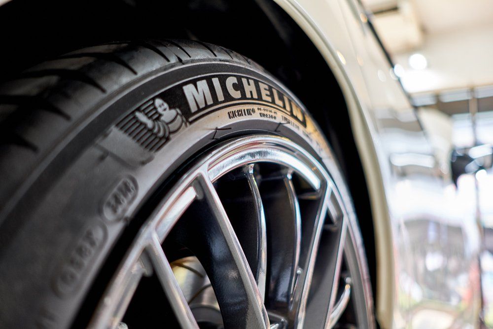 a close up of a michelin tire on a car wheel .
