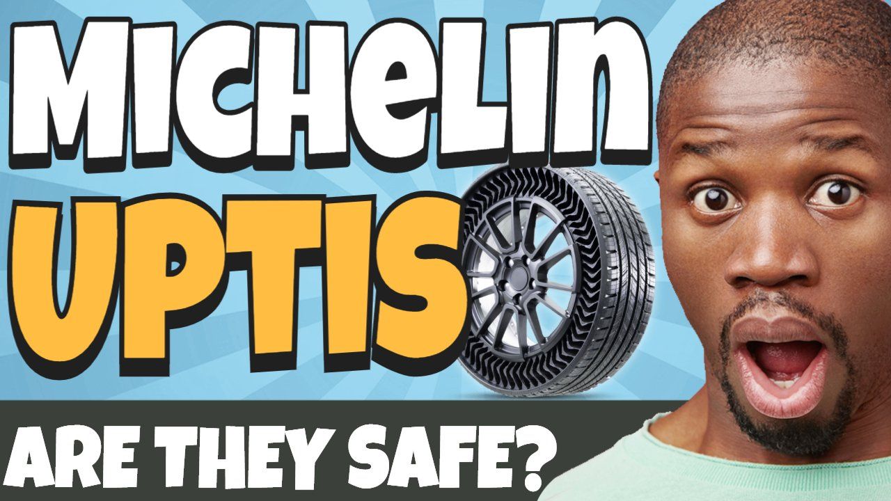 a man is standing in front of a sign that says michelin uptis are they safe