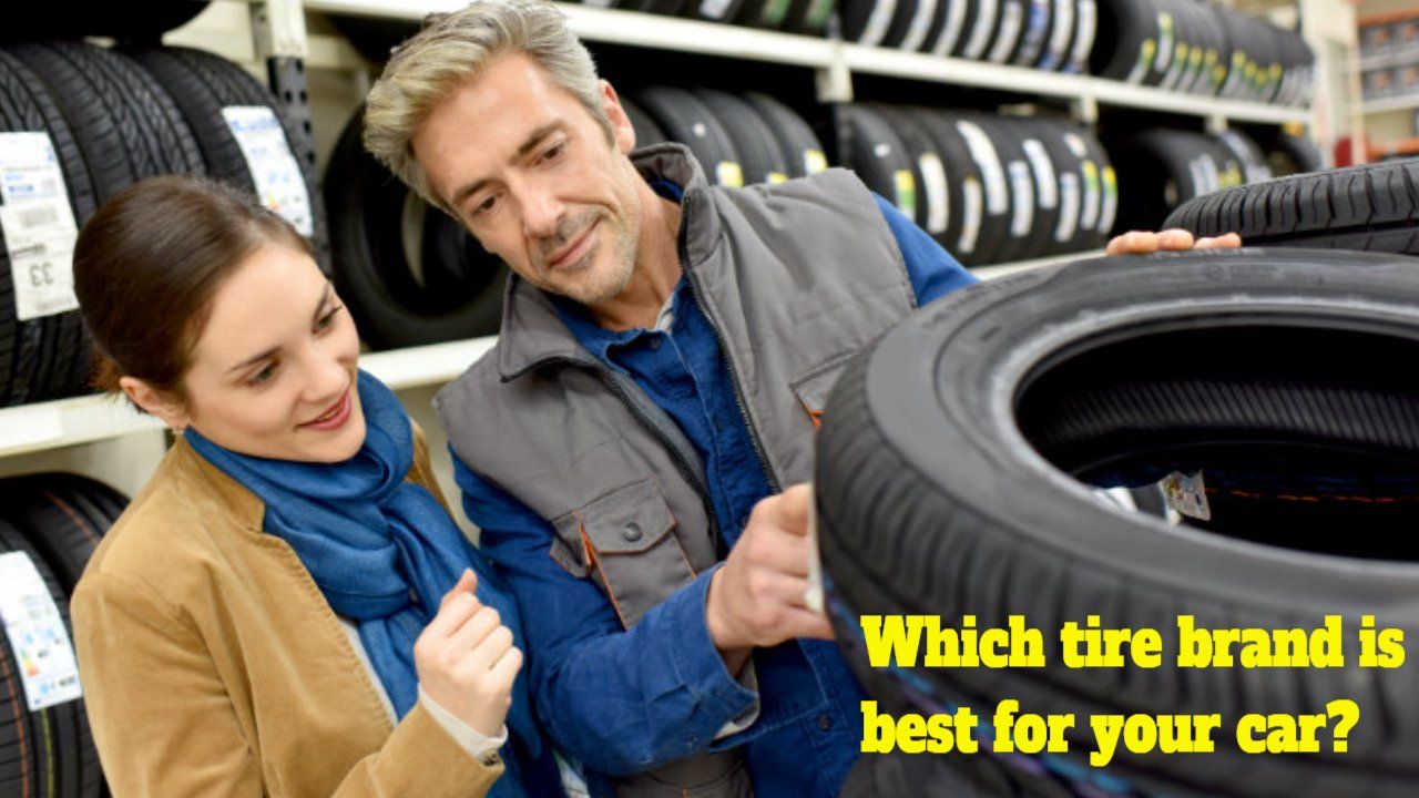 a man and a woman are looking at tires in a store .