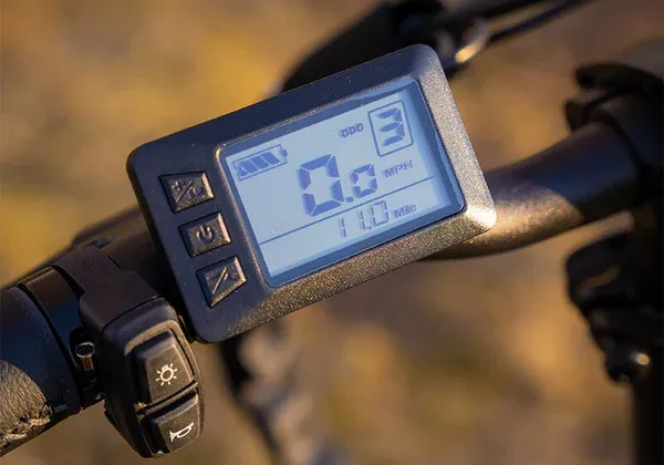 a close up of a digital display on the handlebars of an electric bike .