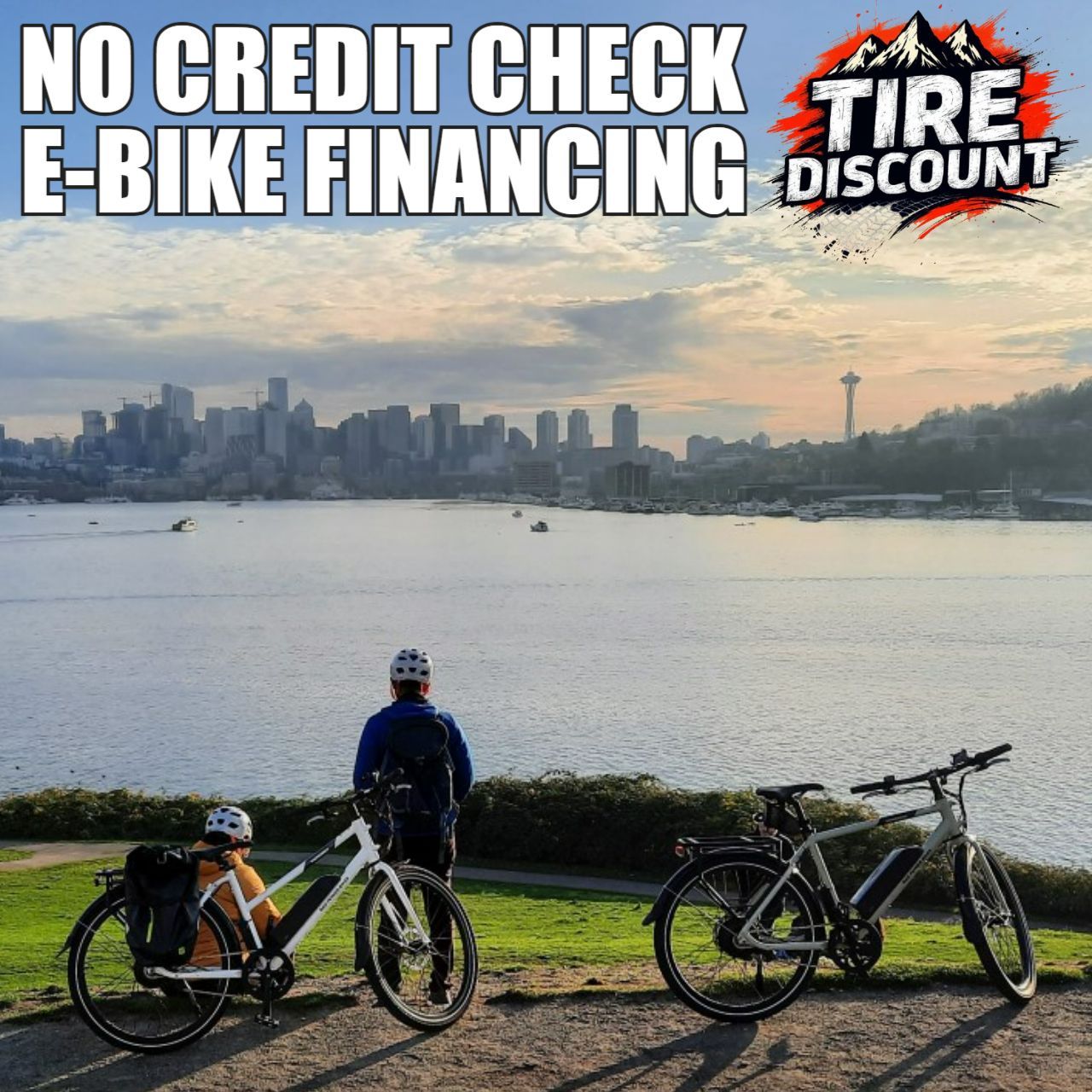 Two bicycles are parked in front of a body of water in the mountains of Seattle, WA