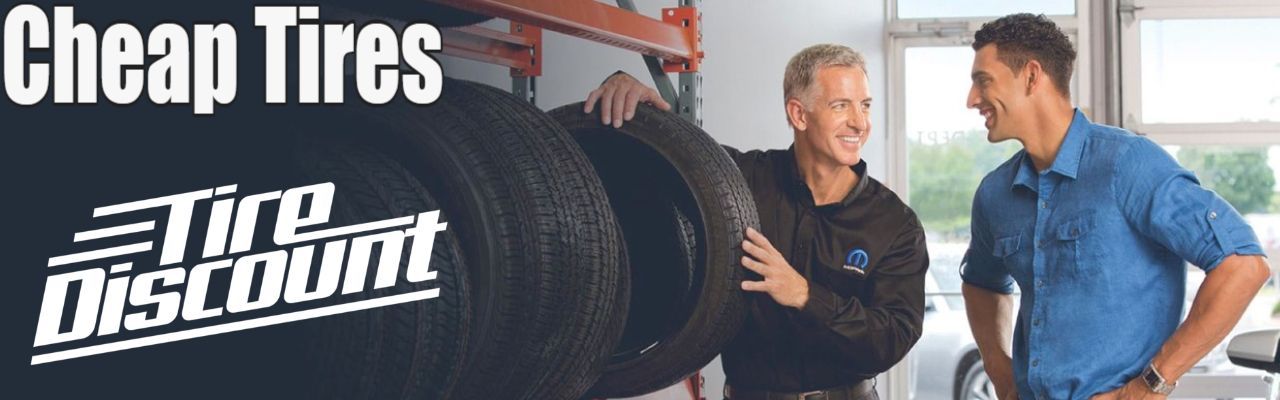 two men are standing next to each other talking about cheap tires.