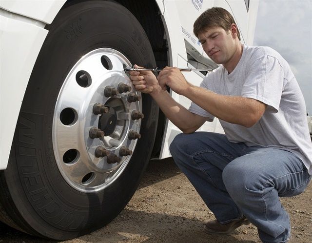CHECKING TIRE PRESSURE ON COMMERCIAL TRUCK